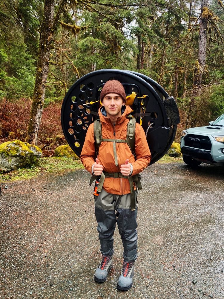 Jake carrying a huge backpack with PIT arrays to capture the movement of tagged juvenile fish