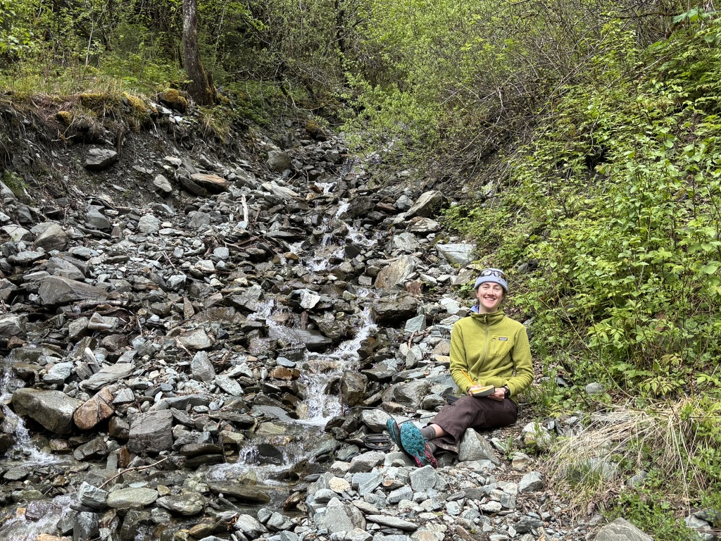 Sydney Jones is sampling in a landslide stream.